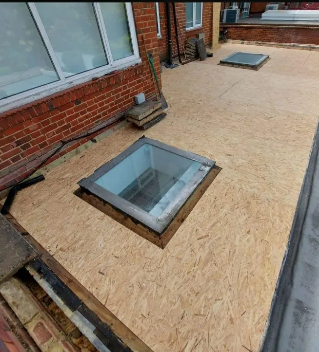 Flat roof before repair — damaged and leaking